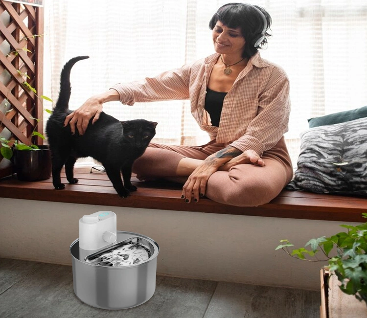 Pet owner petting cat beside Smart Pet Supplies stainless steel water fountain, a premium pet product for quality pet brands.