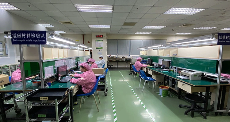 Workers in a cleanroom environment performing quality control checks at computer workstations, indicating a thorough process to prevent automatic cat feeder sourcing pitfalls.