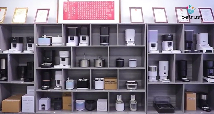 An assembly line inside a factory with workers assembling pet products, demonstrating the reliable manufacturing process for a portion control automatic cat feeder OEM.