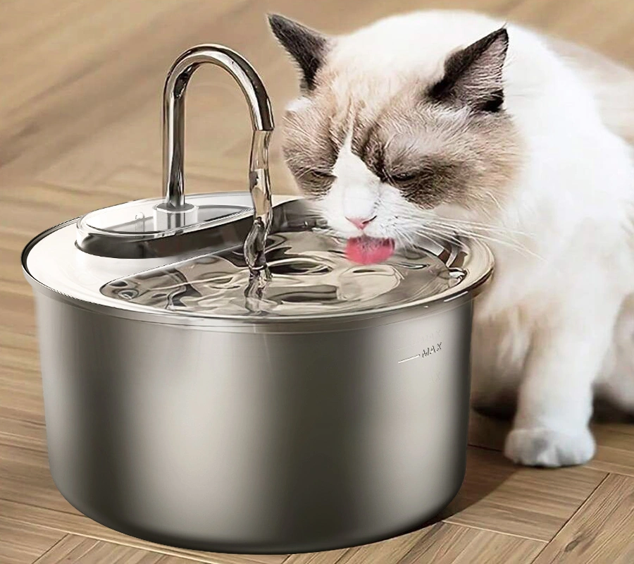 A fluffy white and grey cat drinking from a sleek stainless steel premium OEM cat water fountain, showcasing durability and hygiene.