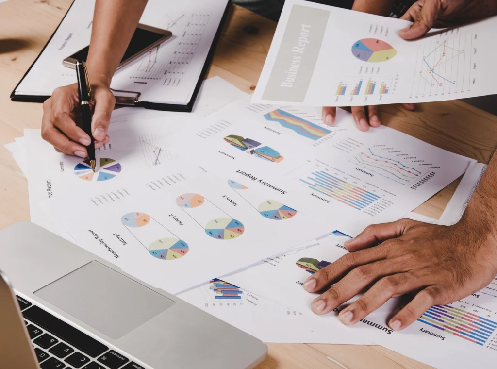 How We Build Every Automatic Cat Water Fountain with Precision Market Research RD Design of Automatic Cat Water Fountain Hands pointing to charts and graphs on a table, representing the Market Research and R&D Design process for the automatic cat water fountain.