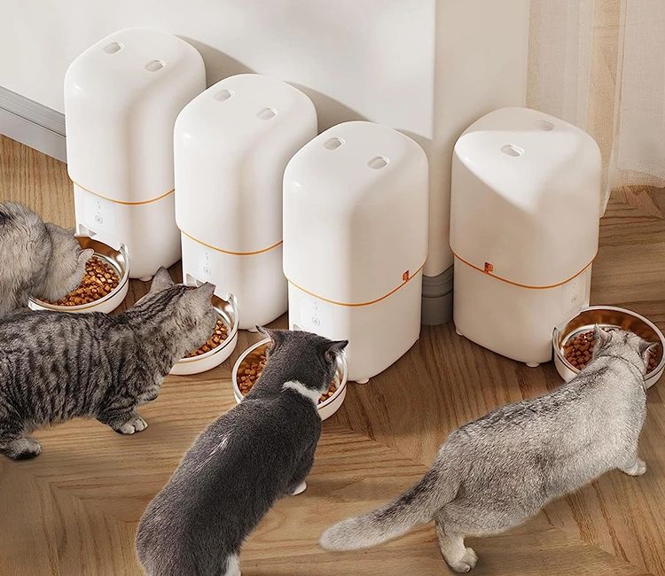 Multi Cat Automatic Feeder Guide One Feeder Per Cat for a Stress Free Home 1 of Multi-Cat Automatic Feeder Ultimate Guide: One Feeder Per Cat for a Stress-Free Home | Luna’s Feeder Diaries Four cats eat from separate white automatic feeders, visually supporting the "one feeder per cat" strategy for a multi-cat automatic feeder setup.