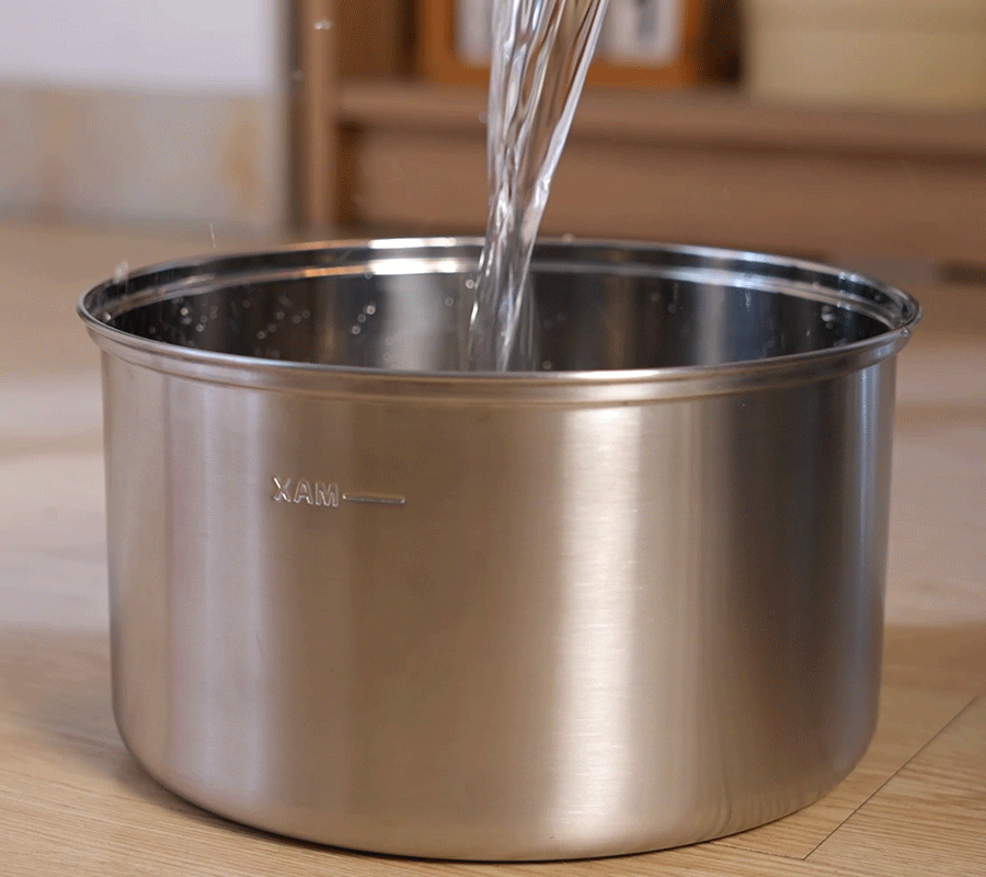 How to Install Use Our Cat Water Fountain Step 2 of Automatic Cat Water Fountain Clear water being poured into the stainless steel tank, filling the automatic cat water fountain to the 'MAX' line.