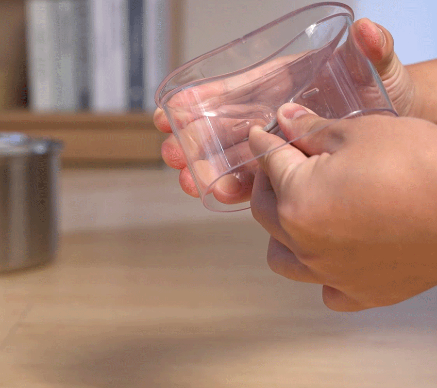 How to Install Use Our Cat Water Fountain Step 4 of Automatic Cat Water Fountain Hands connecting the small water pipe to the pump inside the transparent housing of the automatic cat water fountain.