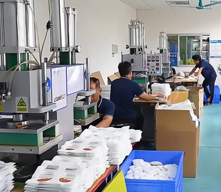 Workers operating heat-pressing machines to assemble filter cartridges in a clean factory environment, representing the quality control of a smart cat water fountain manufacturer in China.
